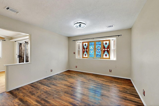 5721 Miller Rd NE, Rio Rancho, NM 87144 - empty room with plenty of natural light, wood finished floors, baseboards, and a textured ceiling