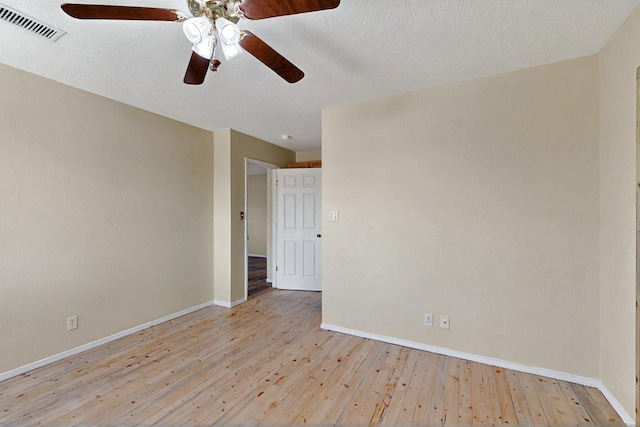 5721 Miller Rd NE, Rio Rancho, NM 87144 - empty room with ceiling fan, baseboards, light wood-type flooring, and a textured ceiling