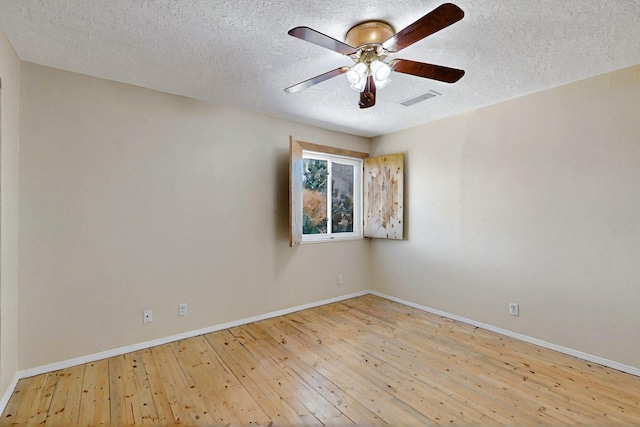 5721 Miller Rd NE, Rio Rancho, NM 87144 - spare room featuring a textured ceiling, hardwood / wood-style floors, baseboards, and a ceiling fan