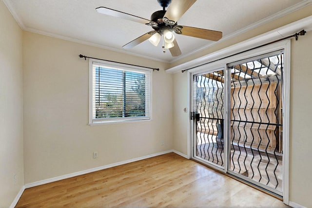 5721 Miller Rd NE, Rio Rancho, NM 87144 - spare room featuring wood finished floors, ornamental molding, a ceiling fan, and baseboards