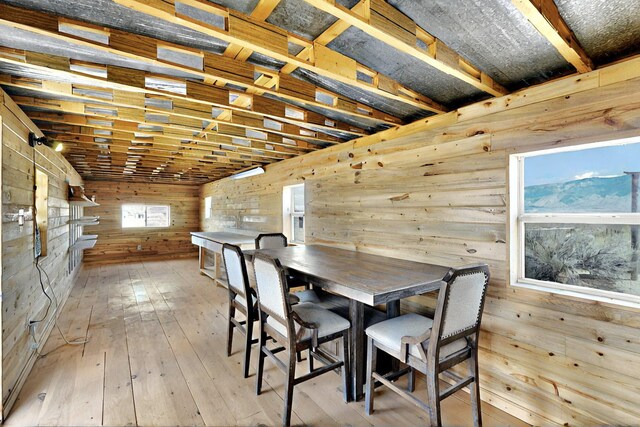 5721 Miller Rd NE, Rio Rancho, NM 87144 - dining area with wood walls and hardwood / wood-style flooring