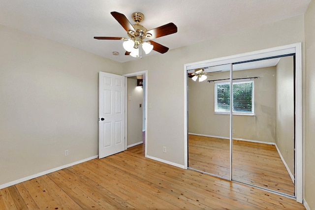5721 Miller Rd NE, Rio Rancho, NM 87144 - unfurnished bedroom featuring hardwood / wood-style flooring, baseboards, a closet, and ceiling fan
