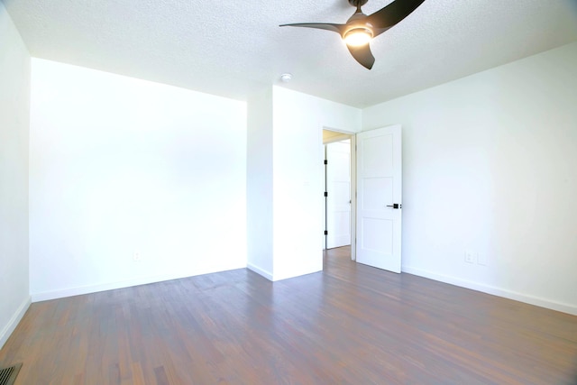445 Rim Rd, Los Alamos, NM 87544 - spare room with dark wood finished floors, ceiling fan, baseboards, and a textured ceiling