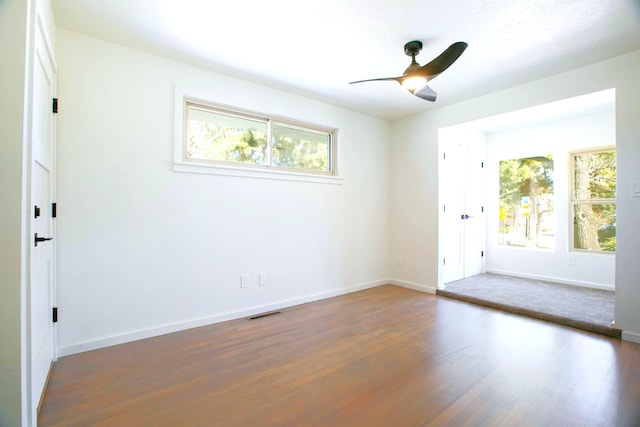 445 Rim Rd, Los Alamos, NM 87544 - empty room with healthy amount of natural light, wood finished floors, ceiling fan, and baseboards