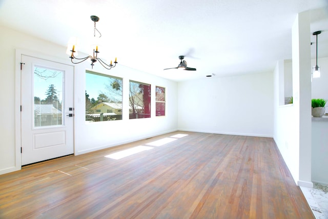 445 Rim Rd, Los Alamos, NM 87544 - unfurnished room with a chandelier, healthy amount of natural light, wood finished floors, and baseboards