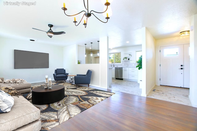 445 Rim Rd, Los Alamos, NM 87544 - living area with baseboards, ceiling fan, and a chandelier