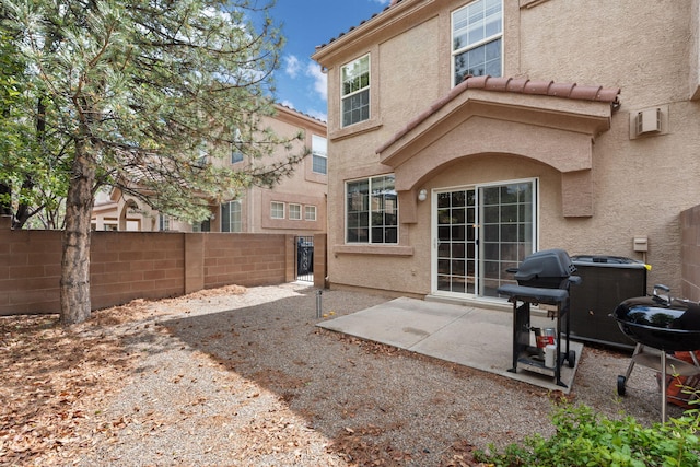 5236 Na Pali St NE, Albuquerque, NM 87111 - back of house with stucco siding, a tiled roof, fence, and a patio area