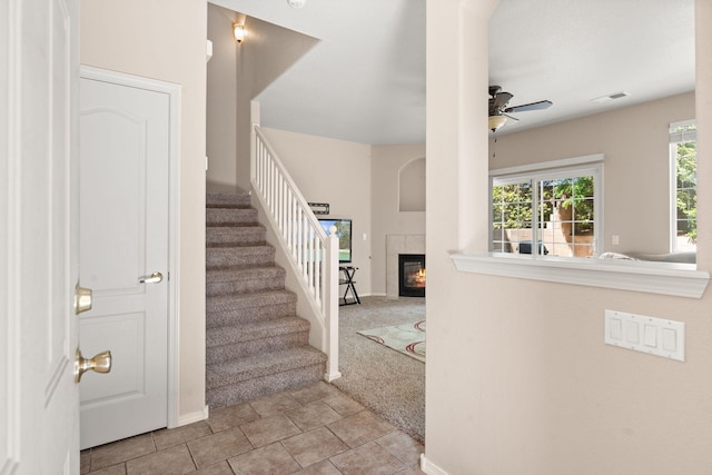 5236 Na Pali St NE, Albuquerque, NM 87111 - stairway with a tiled fireplace, ceiling fan, baseboards, and carpet floors