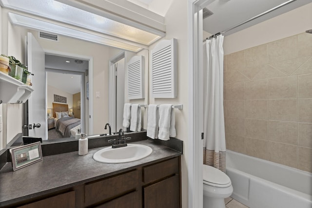 bathroom with toilet, ensuite bathroom, vanity, and shower / bath combo