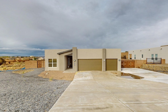 3406 Falkirk Rd NE, Rio Rancho, NM 87144 - southwest-style home featuring a garage, driveway, stucco siding, and fence