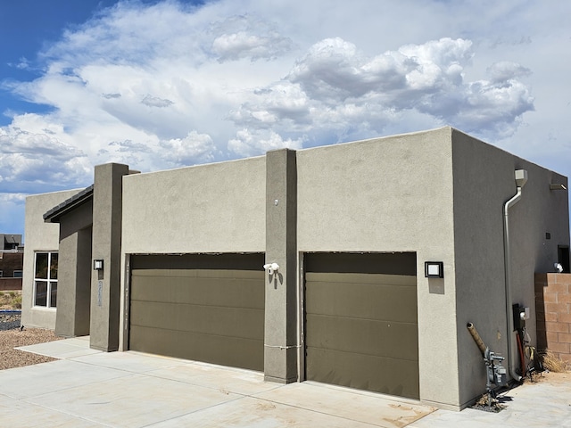 3406 Falkirk Rd NE, Rio Rancho, NM 87144 - view of front of property with stucco siding, concrete driveway, and a garage