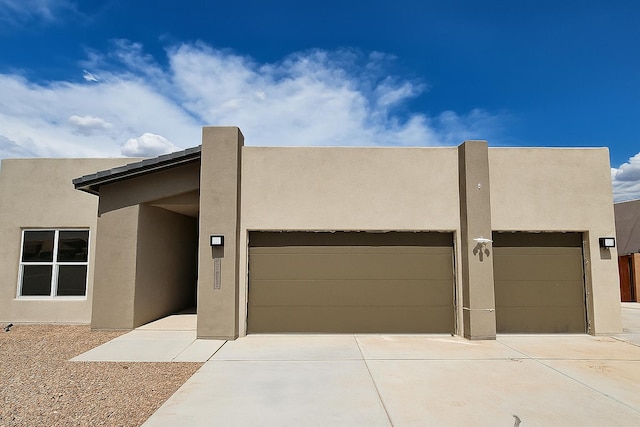 3406 Falkirk Rd NE, Rio Rancho, NM 87144 - pueblo-style home with stucco siding, driveway, and a garage