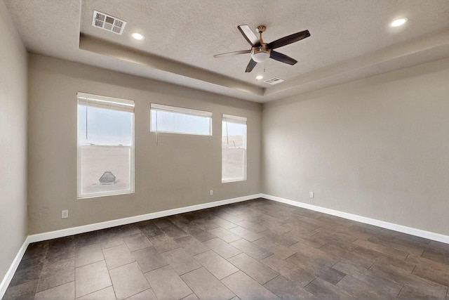 3406 Falkirk Rd NE, Rio Rancho, NM 87144 - empty room featuring a tray ceiling, a ceiling fan, recessed lighting, baseboards, and a textured ceiling