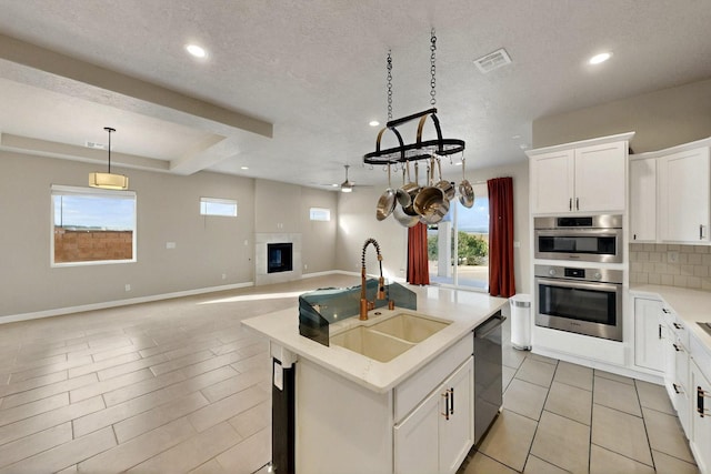 3406 Falkirk Rd NE, Rio Rancho, NM 87144 - kitchen with plenty of natural light, open floor plan, a ceiling fan, recessed lighting, and stainless steel appliances