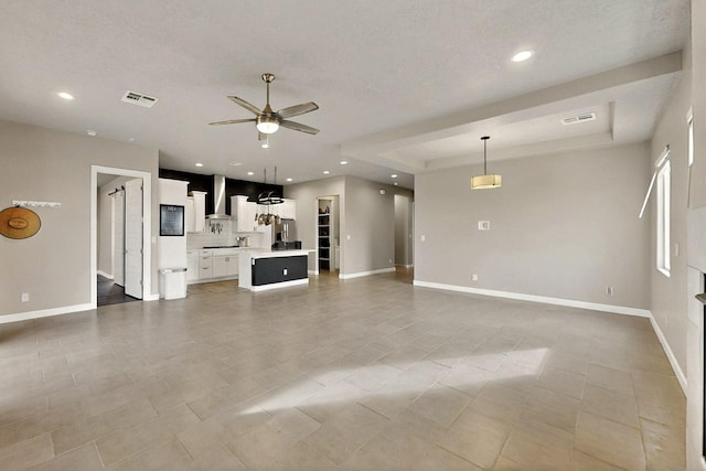 3406 Falkirk Rd NE, Rio Rancho, NM 87144 - unfurnished living room with ceiling fan, baseboards, recessed lighting, light tile patterned flooring, and a raised ceiling