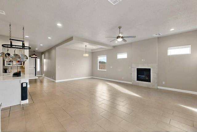 3406 Falkirk Rd NE, Rio Rancho, NM 87144 - unfurnished living room featuring a ceiling fan, healthy amount of natural light, baseboards, and recessed lighting