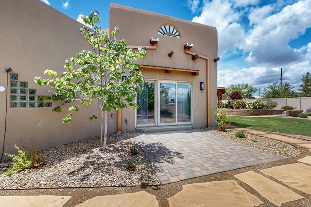 4700 Quaker Heights Pl NW, Albuquerque, NM 87120 - back of house with stucco siding, a patio area, and fence