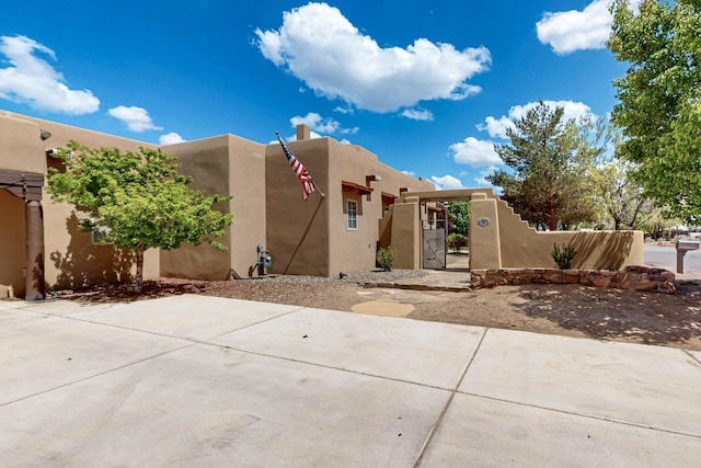 4700 Quaker Heights Pl NW, Albuquerque, NM 87120 - view of front of property featuring a gate, stucco siding, and fence