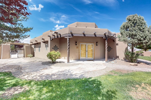 4700 Quaker Heights Pl NW, Albuquerque, NM 87120 - back of property with stucco siding, french doors, and a patio