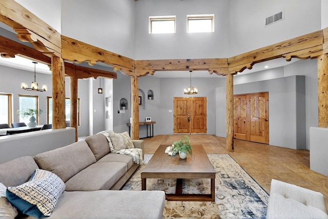 4700 Quaker Heights Pl NW, Albuquerque, NM 87120 - living room with a chandelier, a towering ceiling, healthy amount of natural light, and light tile patterned floors
