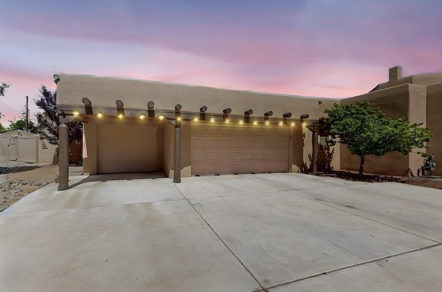 4700 Quaker Heights Pl NW, Albuquerque, NM 87120 - view of front of house with an attached garage, concrete driveway, and stucco siding