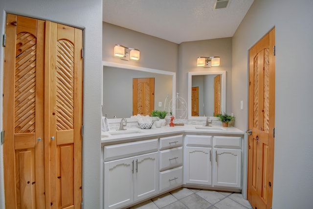 4700 Quaker Heights Pl NW, Albuquerque, NM 87120 - bathroom with a closet, tile patterned floors, and double vanity