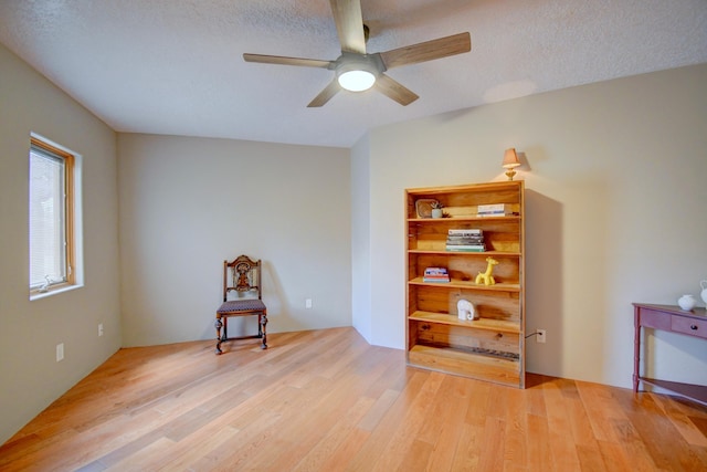 4700 Quaker Heights Pl NW, Albuquerque, NM 87120 - sitting room with light wood-type flooring, a ceiling fan, and a textured ceiling