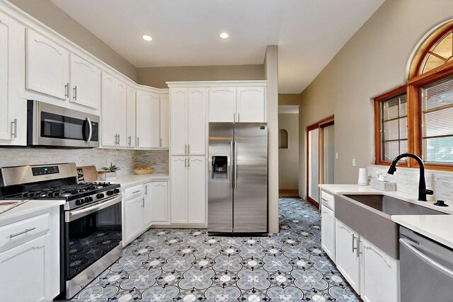 4700 Quaker Heights Pl NW, Albuquerque, NM 87120 - kitchen with stainless steel appliances, a sink, white cabinets, backsplash, and recessed lighting