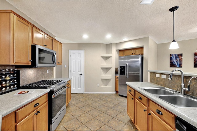 10912 Saltillo St NW, Albuquerque, NM 87114 - kitchen featuring appliances with stainless steel finishes, a sink, backsplash, light countertops, and a textured ceiling