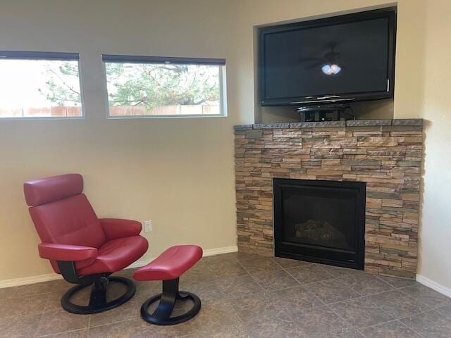10912 Saltillo St NW, Albuquerque, NM 87114 - sitting room with baseboards and a stone fireplace