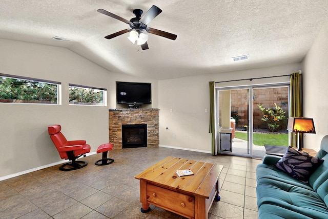 10912 Saltillo St NW, Albuquerque, NM 87114 - tiled living room featuring lofted ceiling, baseboards, a fireplace, a ceiling fan, and a textured ceiling