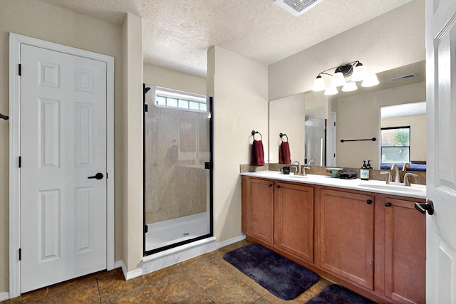 10912 Saltillo St NW, Albuquerque, NM 87114 - full bath featuring a shower stall, plenty of natural light, double vanity, a textured ceiling, and baseboards