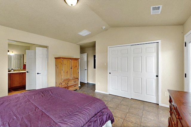 10912 Saltillo St NW, Albuquerque, NM 87114 - tiled bedroom with baseboards, lofted ceiling, a closet, and connected bathroom