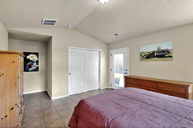 10912 Saltillo St NW, Albuquerque, NM 87114 - bedroom featuring lofted ceiling, dark tile patterned floors, baseboards, a closet, and a textured ceiling