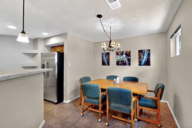 10912 Saltillo St NW, Albuquerque, NM 87114 - tiled dining room featuring baseboards, a textured ceiling, and a chandelier