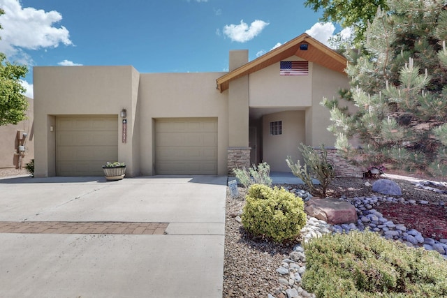 10912 Saltillo St NW, Albuquerque, NM 87114 - view of front of property featuring stucco siding, driveway, an attached garage, and a chimney