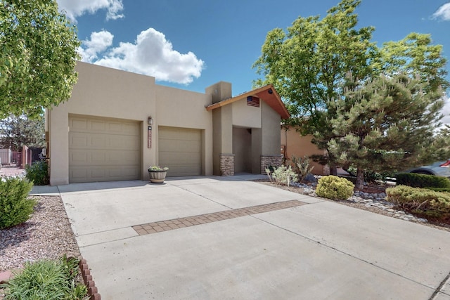 10912 Saltillo St NW, Albuquerque, NM 87114 - view of front of property with driveway, a garage, stucco siding, and stone siding