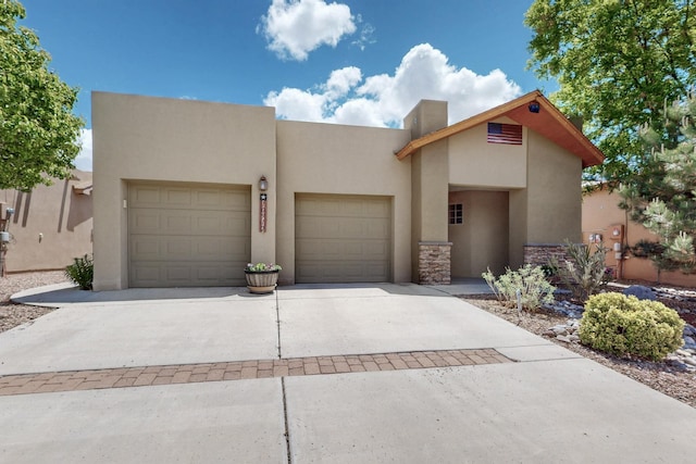 10912 Saltillo St NW, Albuquerque, NM 87114 - view of front facade featuring concrete driveway, stucco siding, and a garage