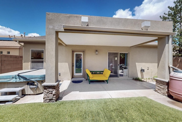 10912 Saltillo St NW, Albuquerque, NM 87114 - back of property with a hot tub, stucco siding, and a patio