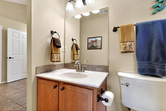 10912 Saltillo St NW, Albuquerque, NM 87114 - half bath featuring tile patterned floors, vanity, toilet, and a textured wall