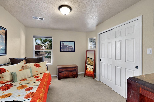10912 Saltillo St NW, Albuquerque, NM 87114 - bedroom with light carpet, a textured ceiling, a closet, and baseboards