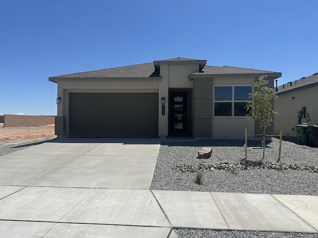 4114 Silver Springs Rd NE, Rio Rancho, NM 87144 - prairie-style home with a garage, driveway, and stucco siding