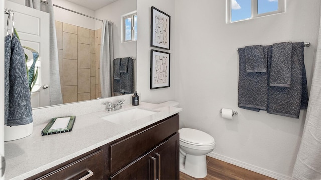 4114 Silver Springs Rd NE, Rio Rancho, NM 87144 - bathroom featuring baseboards, toilet, wood finished floors, vanity, and a shower with shower curtain