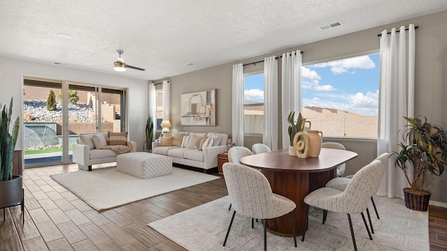 4114 Silver Springs Rd NE, Rio Rancho, NM 87144 - dining area featuring a textured ceiling, wood finished floors, and ceiling fan