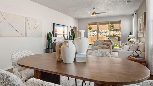 4114 Silver Springs Rd NE, Rio Rancho, NM 87144 - dining room featuring ceiling fan, a textured ceiling, and wood finished floors