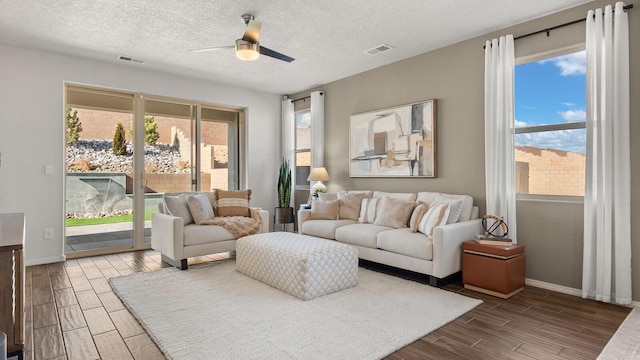 4114 Silver Springs Rd NE, Rio Rancho, NM 87144 - living room with wood finish floors, ceiling fan, plenty of natural light, baseboards, and a textured ceiling
