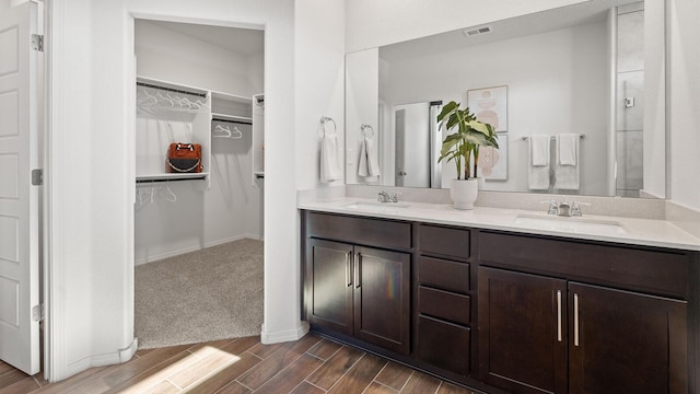 4114 Silver Springs Rd NE, Rio Rancho, NM 87144 - full bathroom featuring wood finished floors, double vanity, a spacious closet, and baseboards