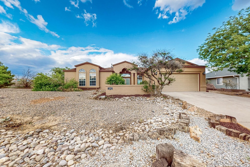 2598 Shavano Peak Dr NE, Rio Rancho, NM 87144 - mediterranean / spanish-style house featuring concrete driveway, a garage, and stucco siding