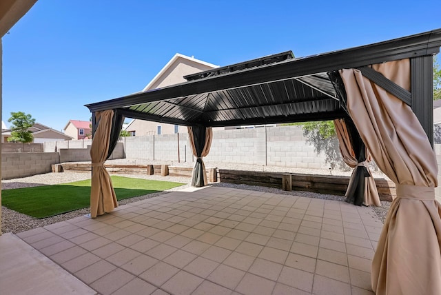 view of patio featuring a gazebo and a fenced backyard