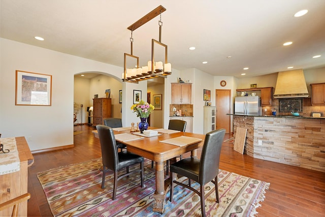 6119 La Paz Rd NE, Rio Rancho, NM 87144 - dining area featuring arched walkways, hardwood / wood-style flooring, and recessed lighting